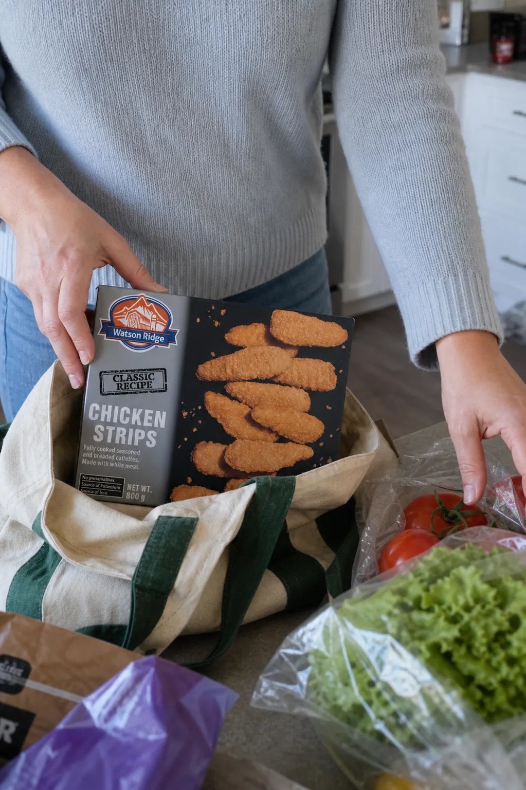 Watson Ridge chicken strips being unpacked with groceries in a home kitchen