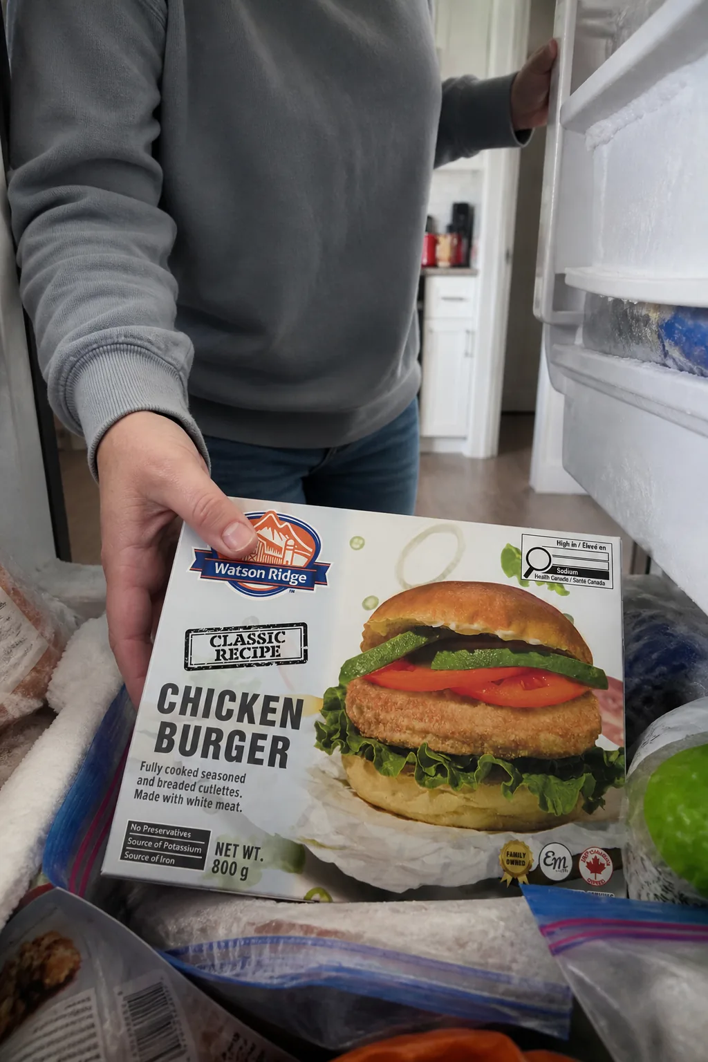 A Watson Ridge chicken burger package being placed into a home freezer