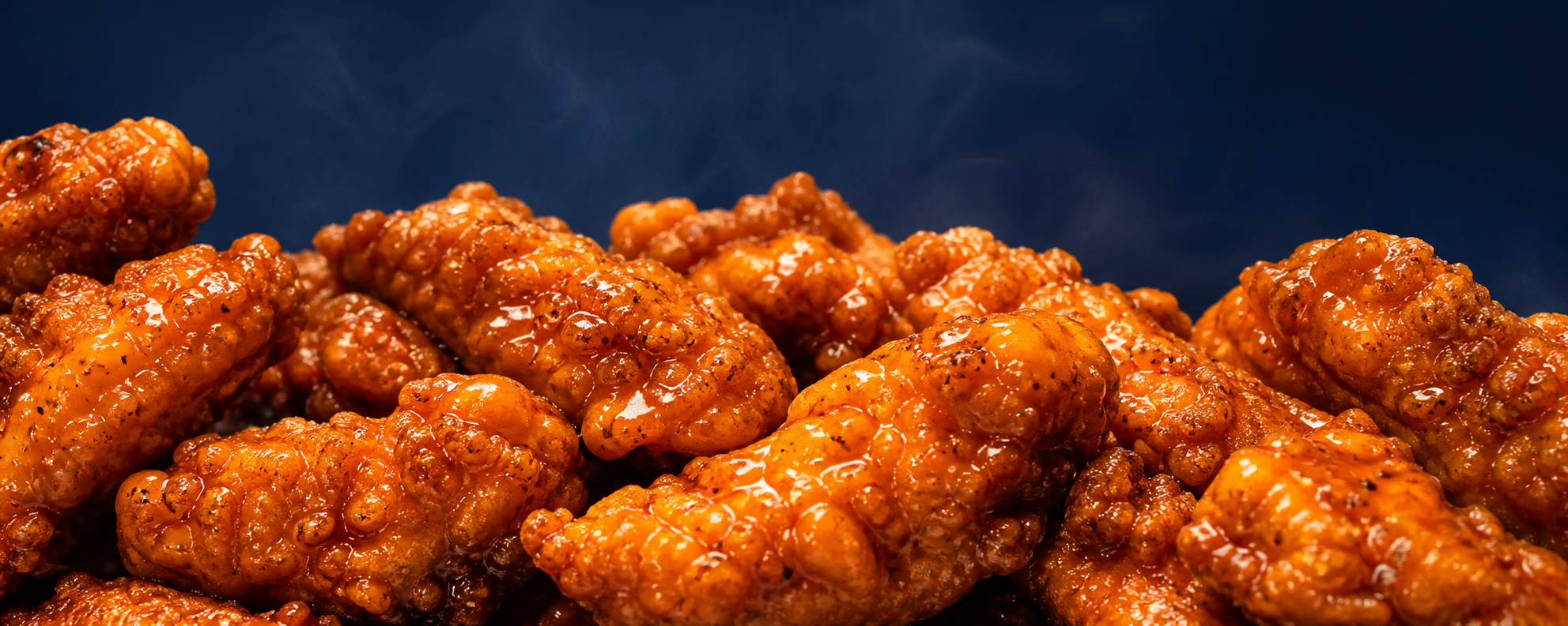 Close-up of glossy sauced chicken pieces